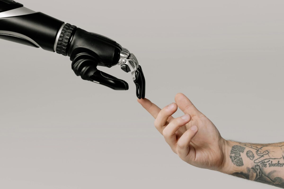 Robotic hand touching a human hand